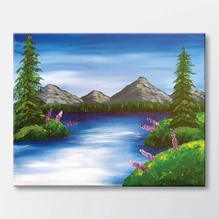 Mountain Lake Retreat painting kit featuring a pine-framed mountain lake with wildflowers - beginner paint-at-home project with canvas, paints, and video tutorial.