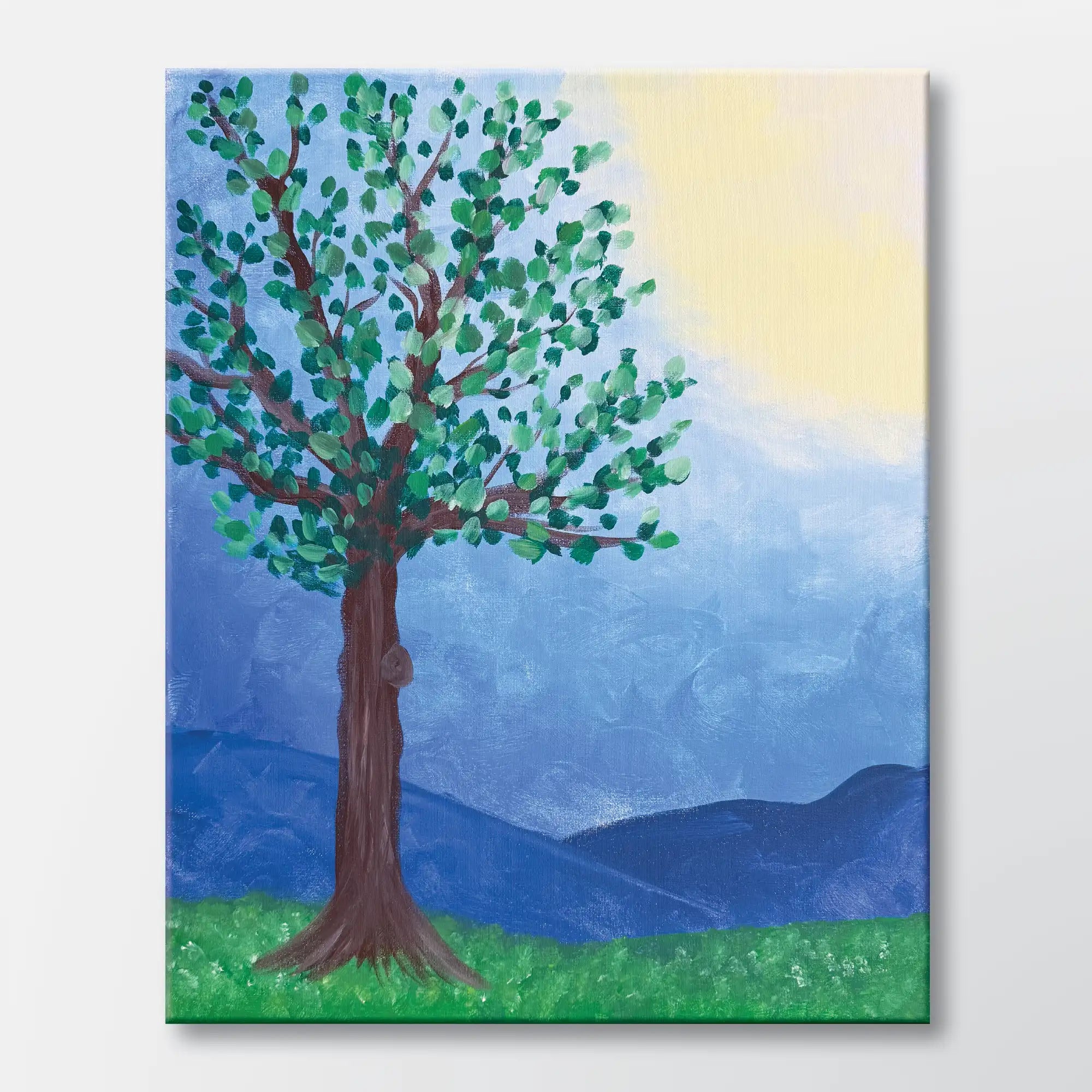 Springtime Tree painting kit featuring a bright spring tree with green leaves, rolling hills, and a warm sky – beginner paint at home project with canvas, paints, and video.